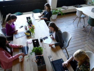 a group of people sitting around a wooden table